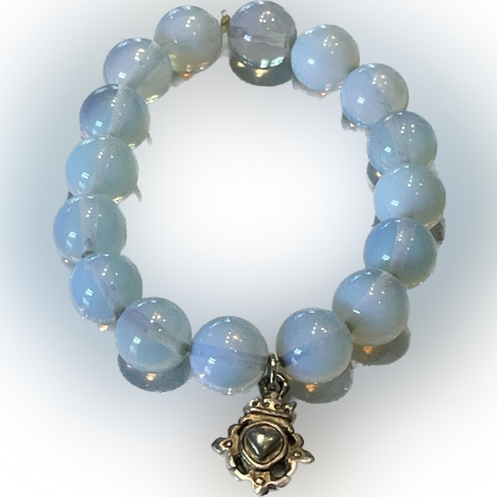 Beautiful Clear Light Blue beaded stretch bracelet with Emblem .
